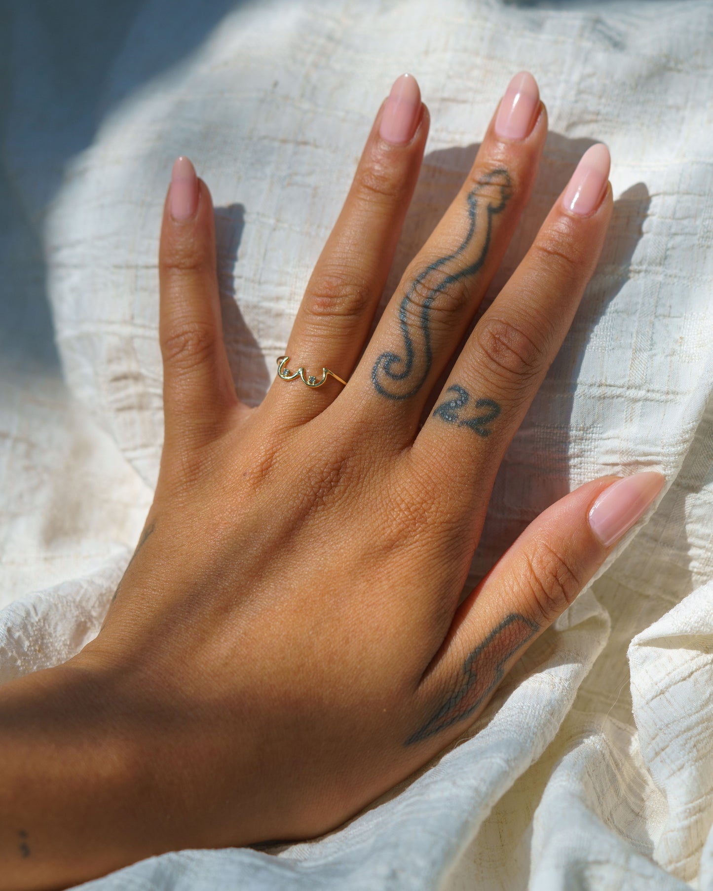Salt & Pepper Diamond Boob Ring modeled on a hand