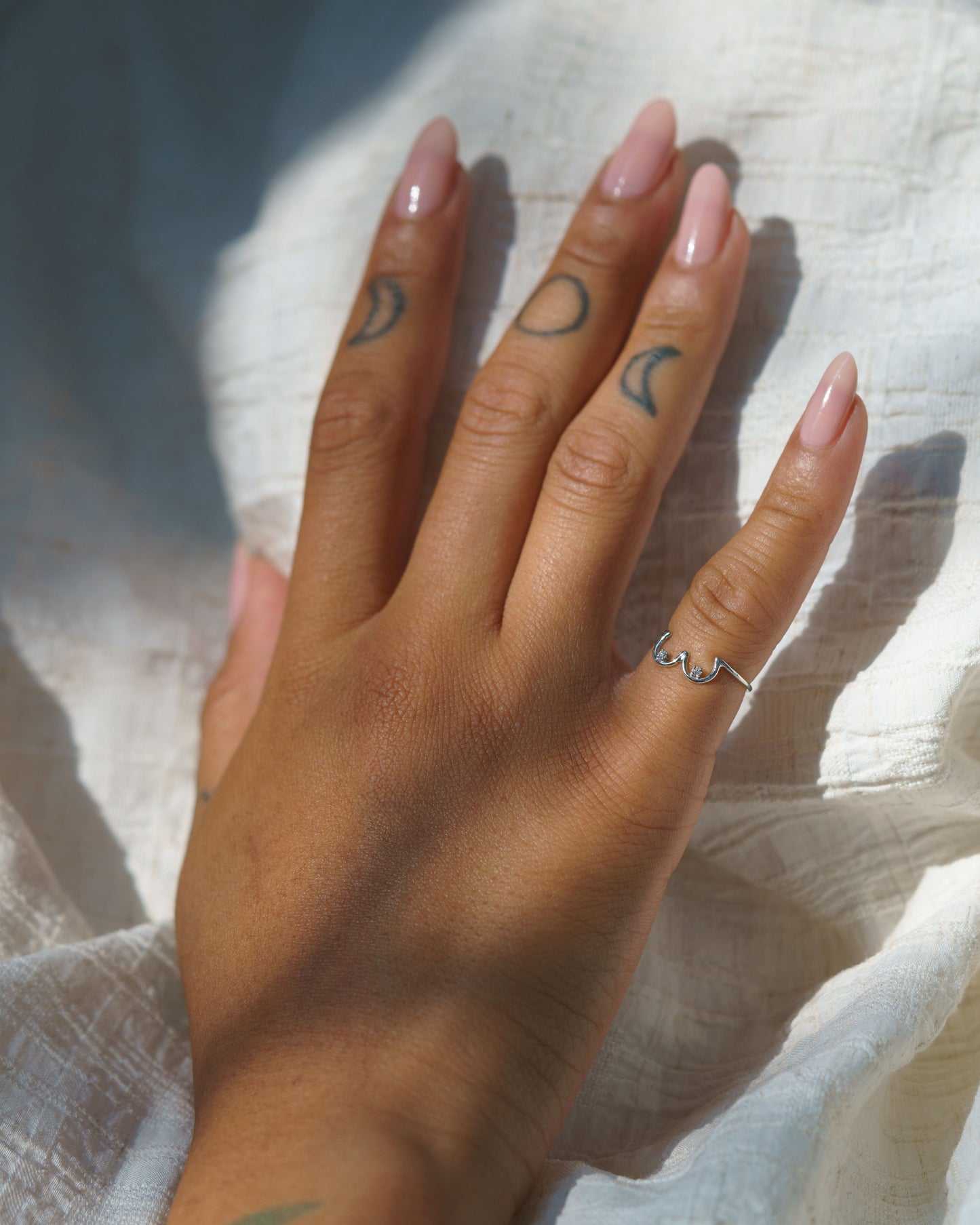 White Diamond Boob Ring in 14k white gold modeled on a hand