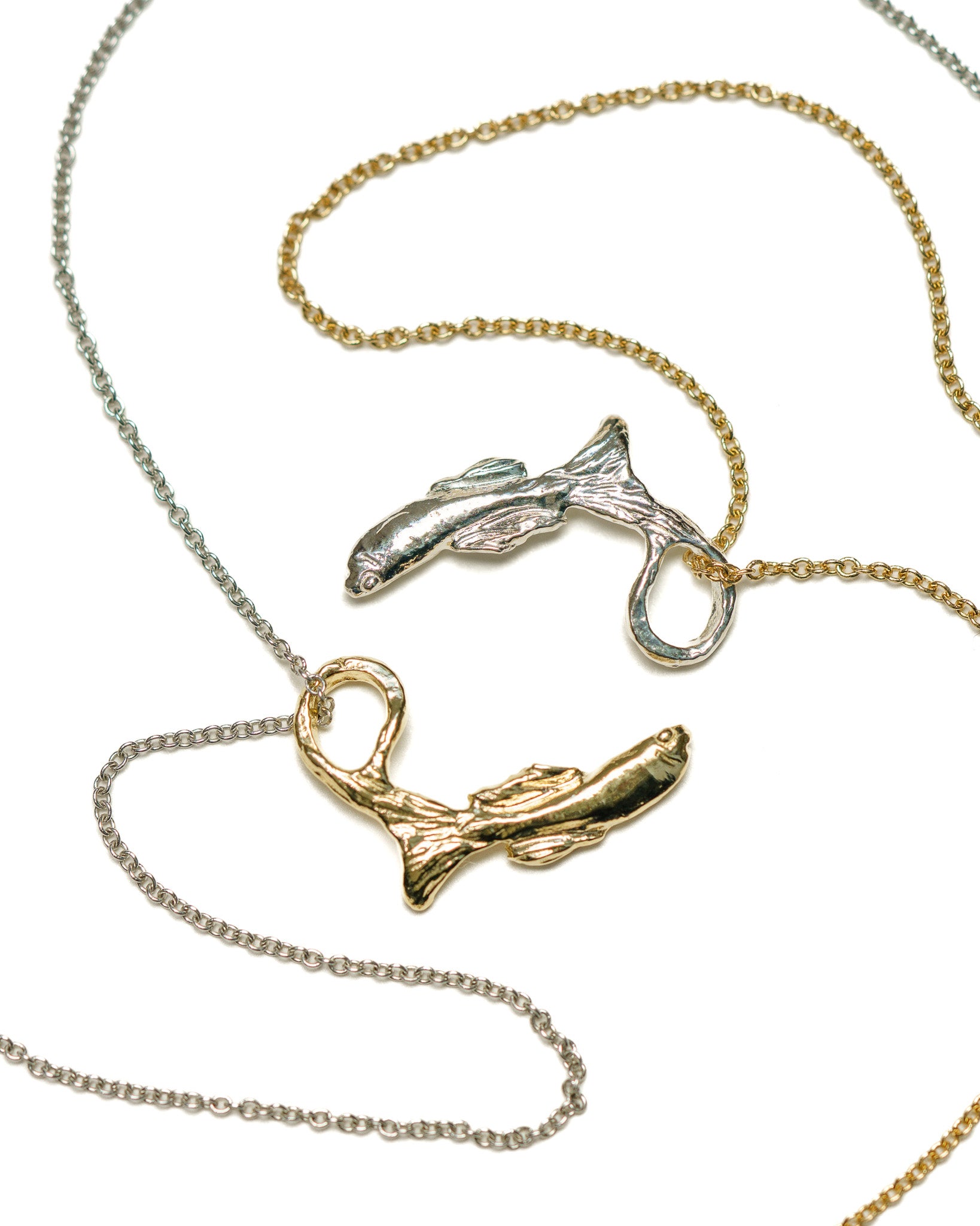 gold baby betta charm on a silver chain & silver baby betta charm on a gold chain