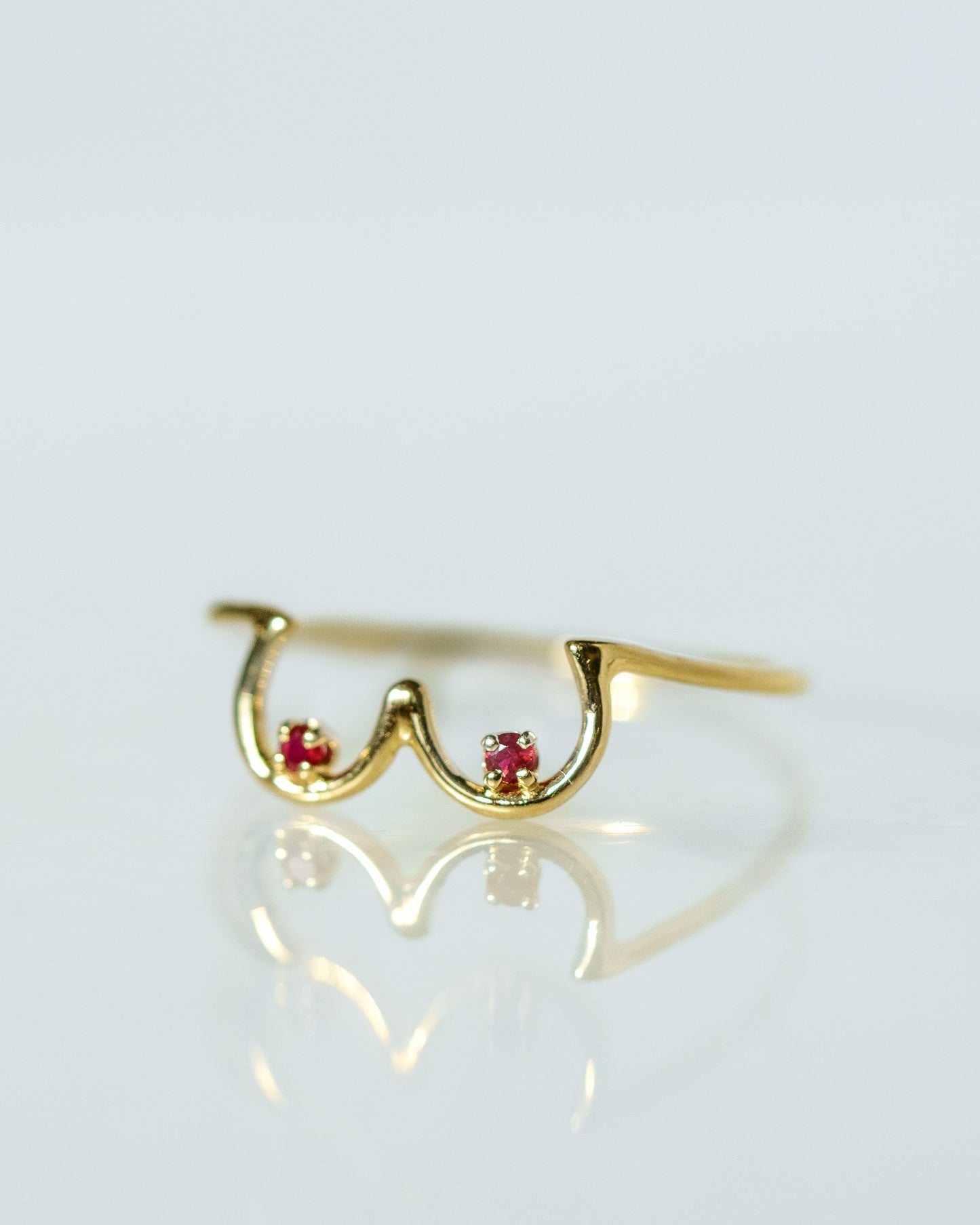 Side view of Ruby Boob Ring in yellow gold