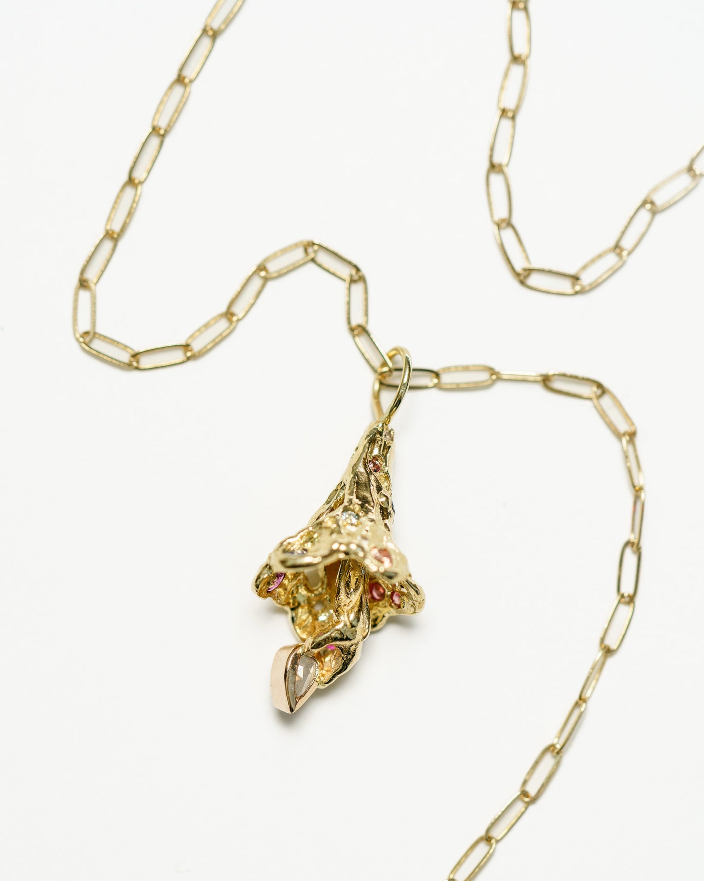 Fairy Bell Charm with colorful sapphires and a pear diamond on a yellow gold chain