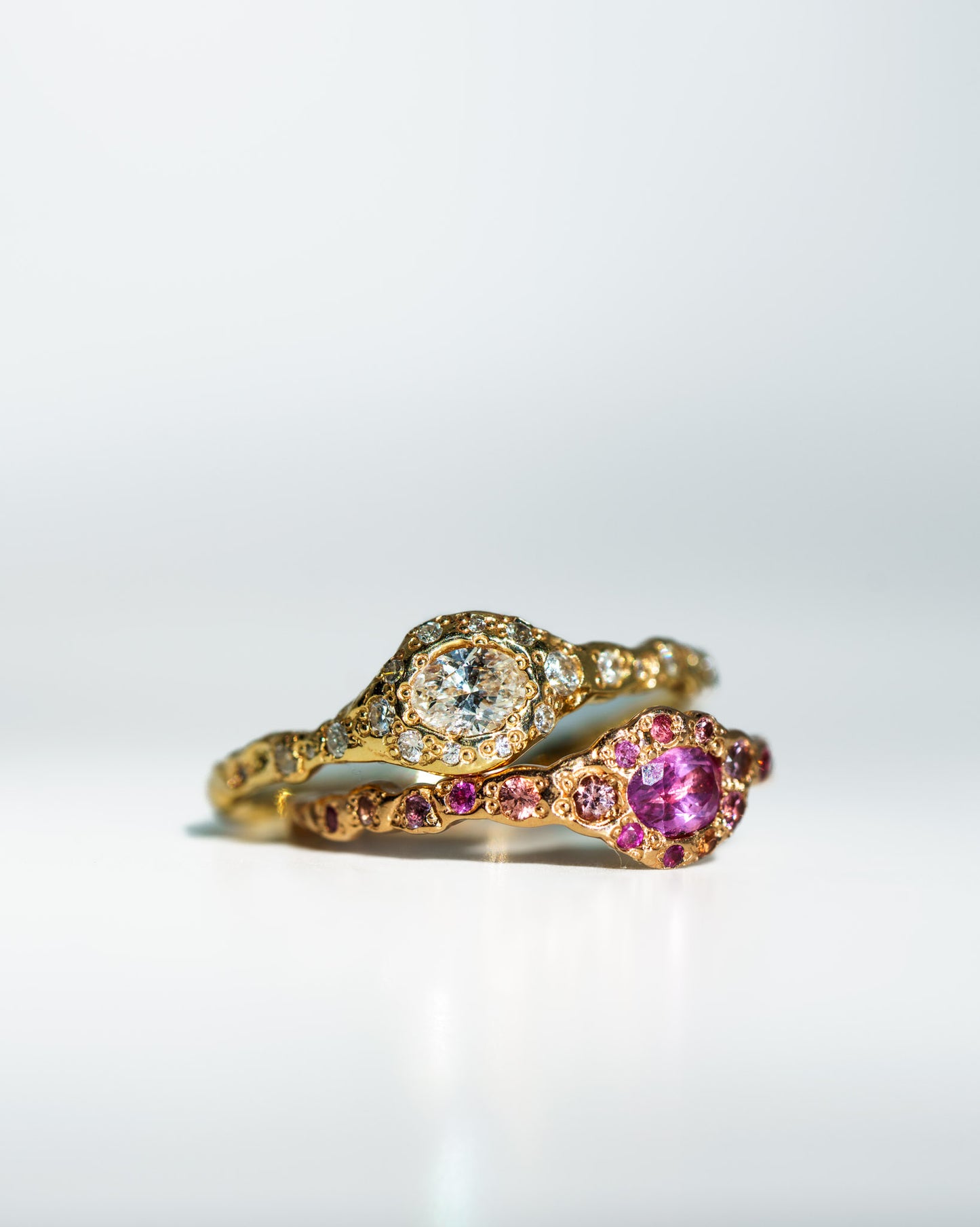 Diamond Fairy Ring in 14k yellow gold stacked with Pink Sapphire Fairy Ring in 14k rose gold