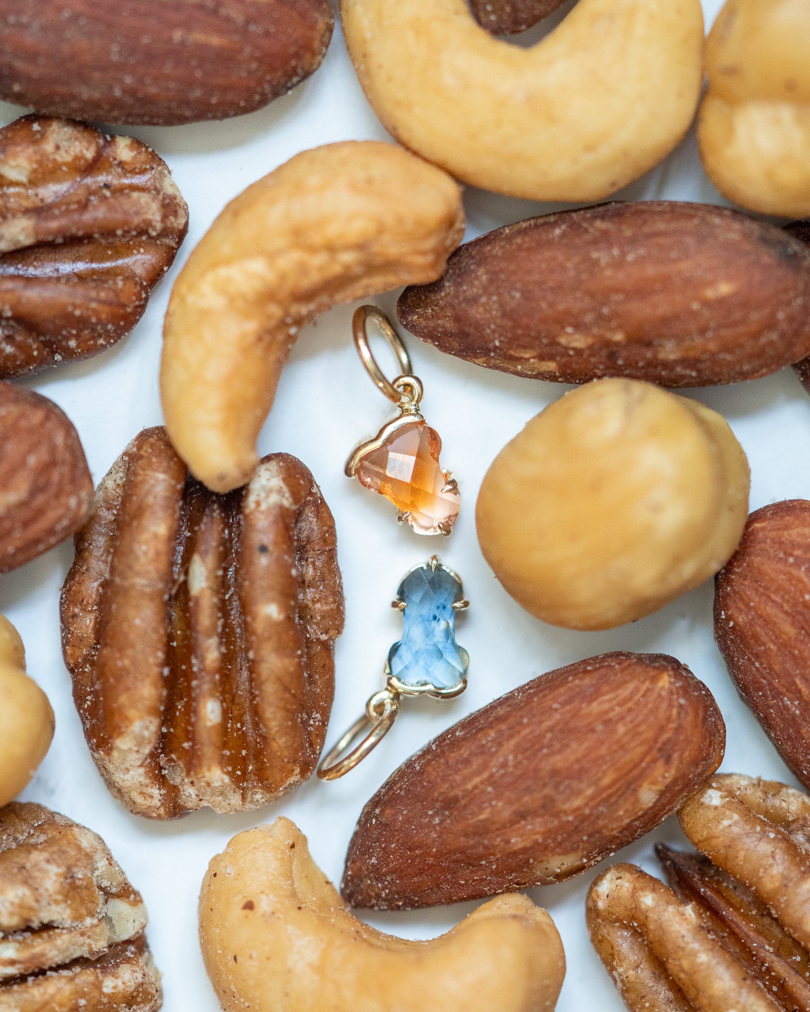 Hermes Charms displayed on a tray of nuts