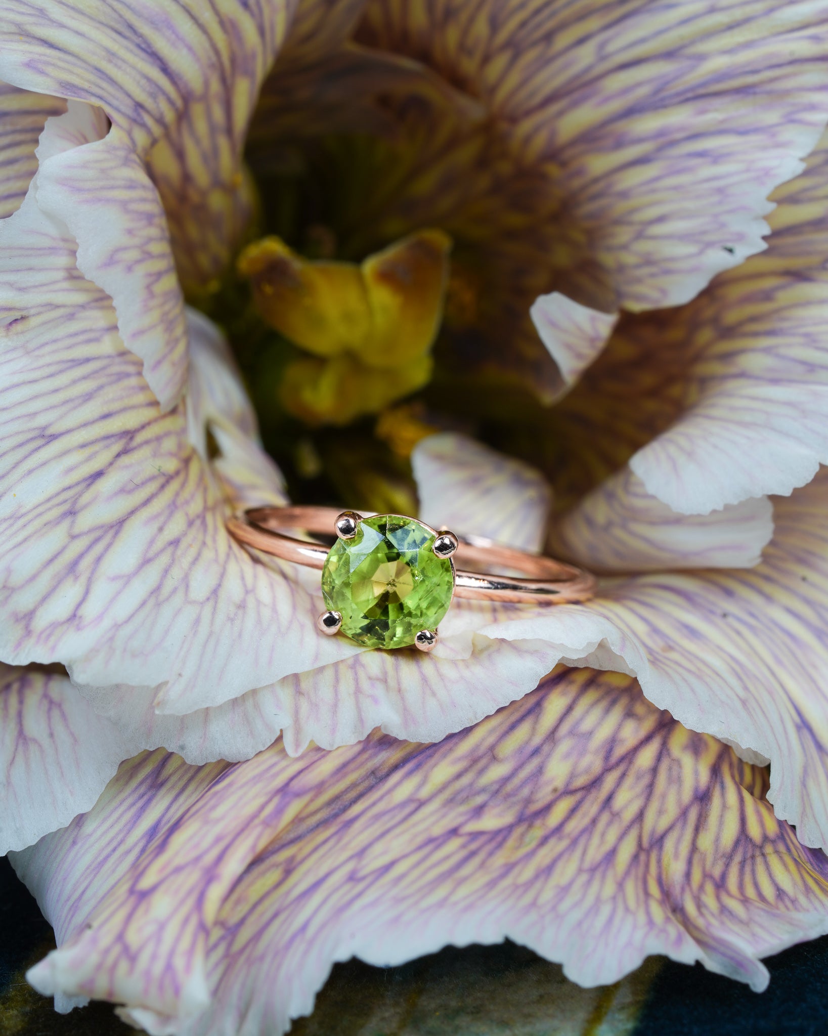 June's Peridot Ring nestled in a flower