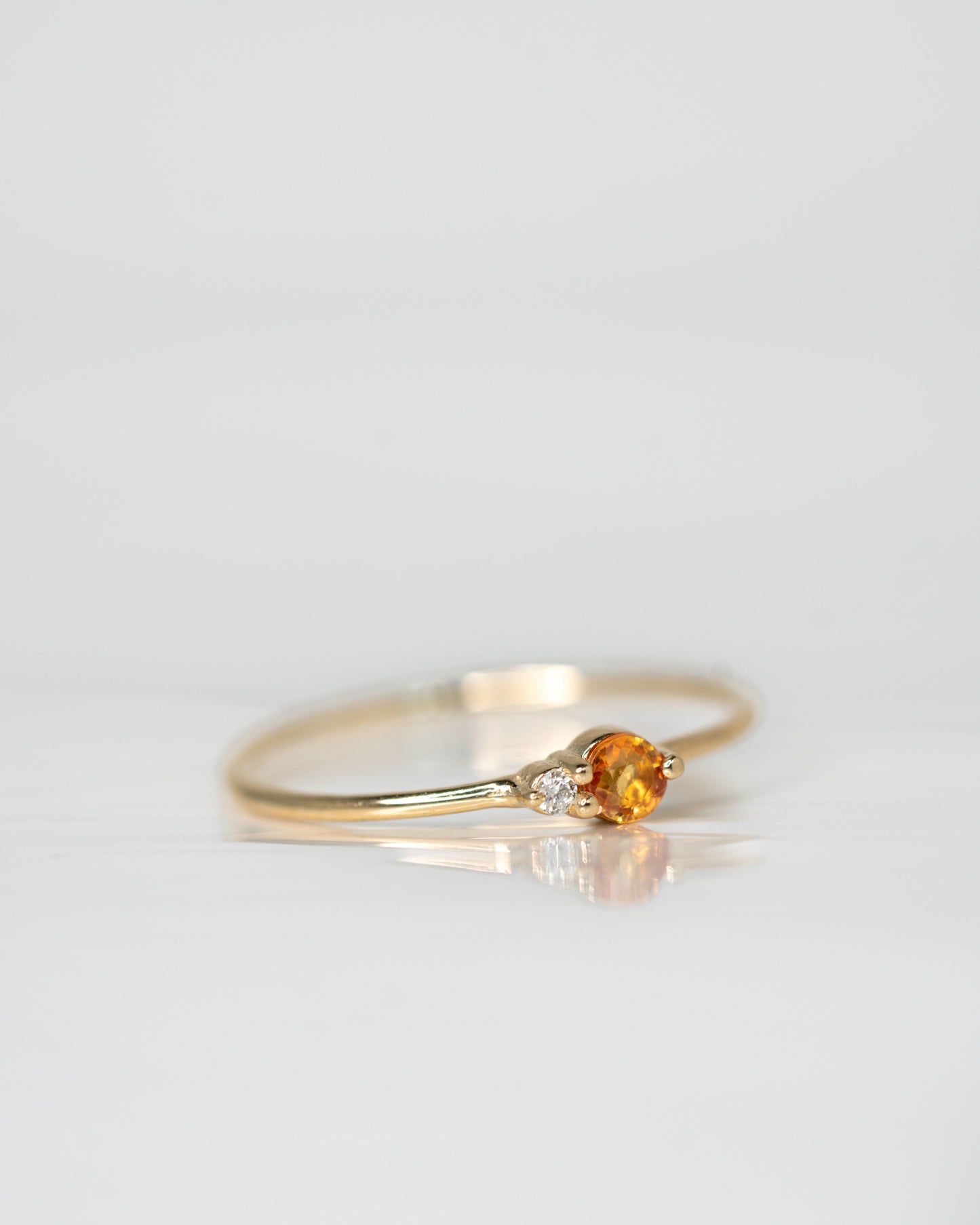 Side view of Peach Sapphire Arktos Ring set in 14k yellow gold