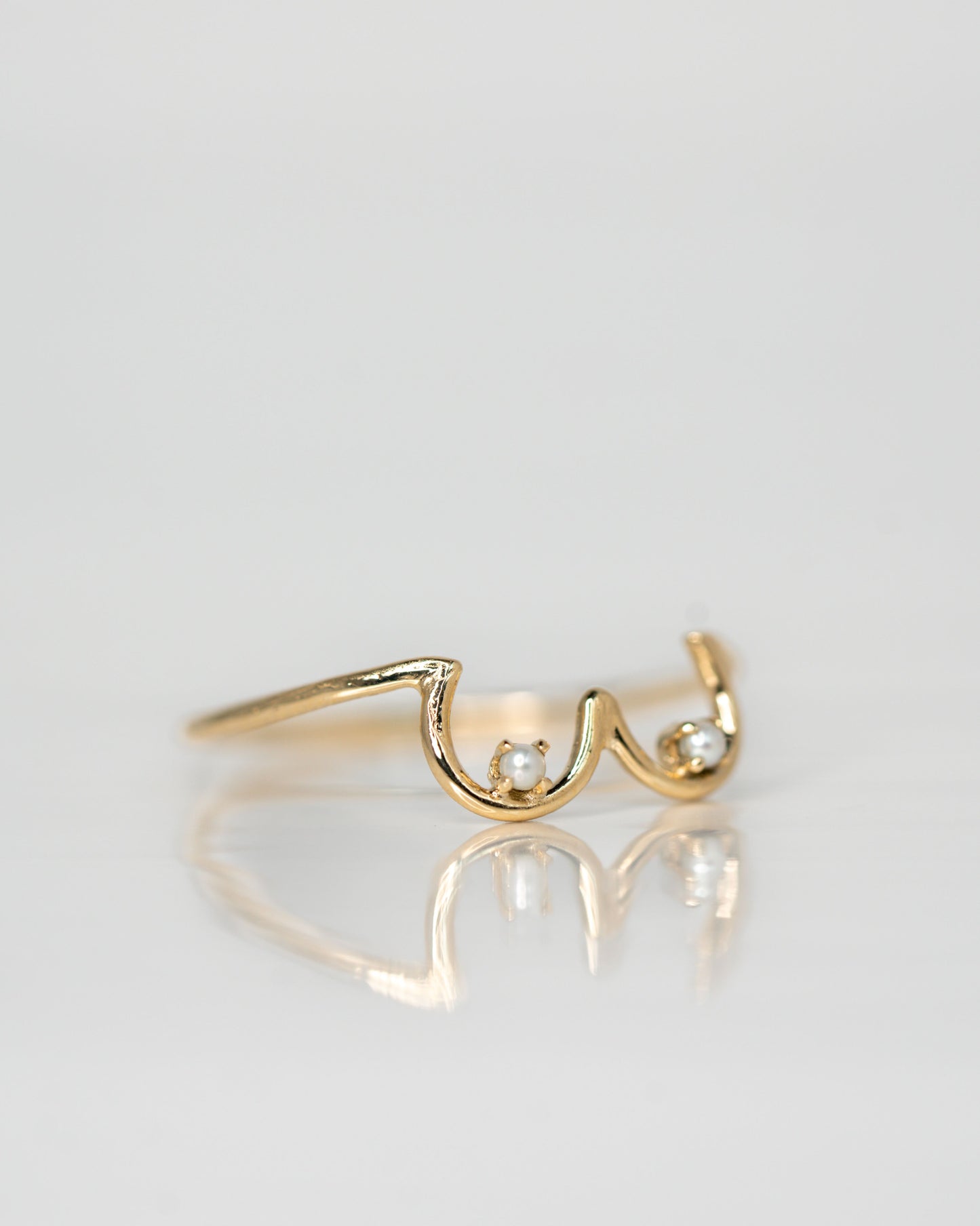 Side view of Pearl Boob Ring set in 14k yellow gold