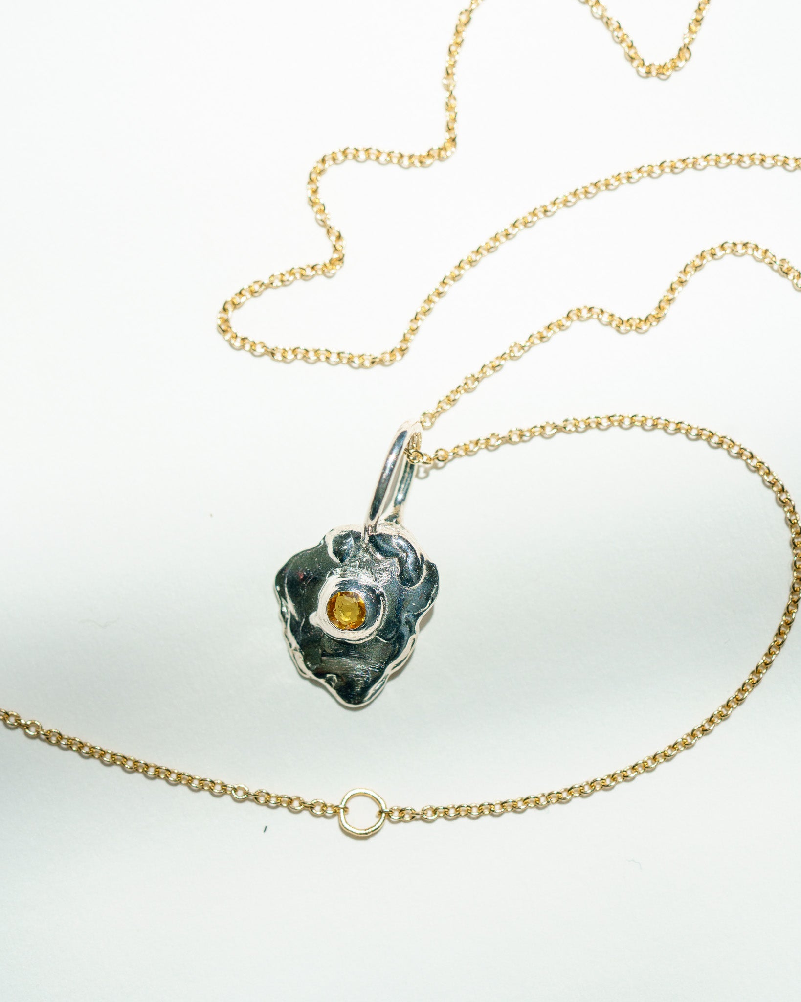 Sunnyside charm in sterling silver with a yellow sapphire yolk on a yellow gold chain
